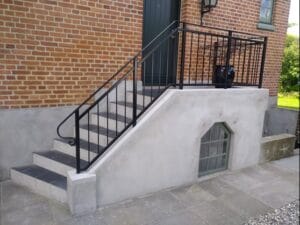 Concrete stairs with black metal railing
