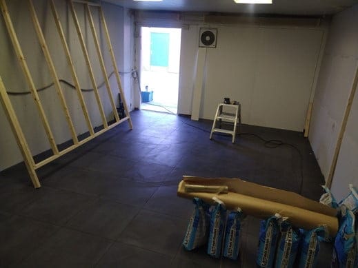 Room under construction with wooden frame and tiles