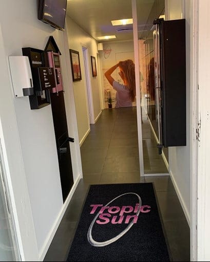 Tropic Sun salon entrance hallway with logo mat