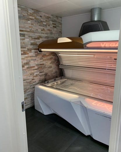 Modern tanning bed in a small spa room