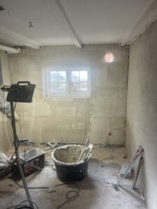 Room under renovation with plaster tools and window