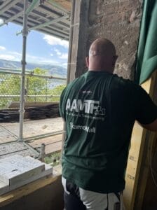 Construction worker building near scenic lake view